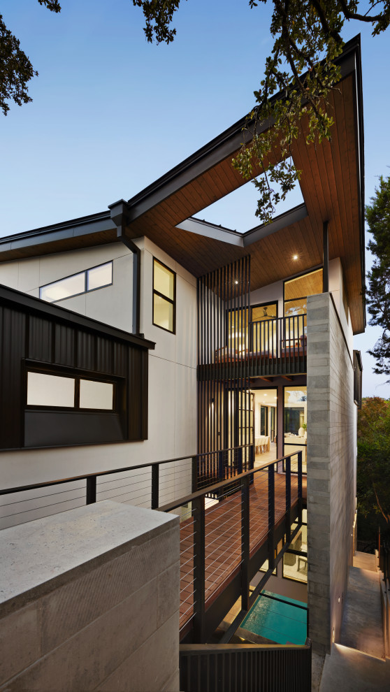 Front door - mid-sized modern dark wood floor, brown floor and wood ceiling front door idea in Austin with white walls and a glass front door