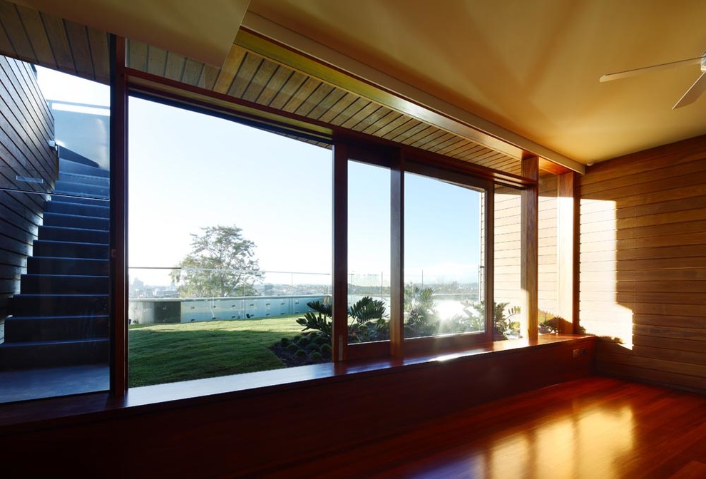 Photo of an expansive contemporary sunroom in Brisbane with medium hardwood floors and a standard ceiling.