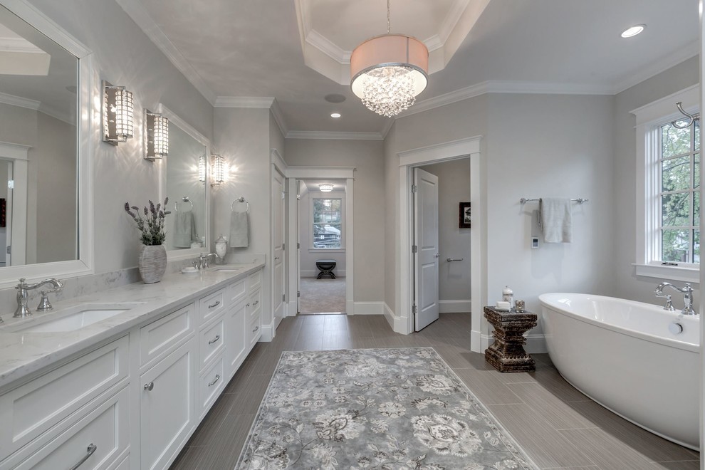 Inspiration for a large country master bathroom in DC Metro with beige walls, an undermount sink, quartzite benchtops, shaker cabinets, white cabinets, a freestanding tub and porcelain floors.
