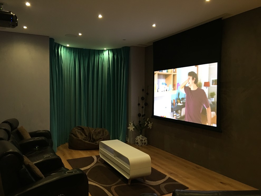 Design ideas for a medium sized modern enclosed home cinema in London with brown walls and a projector screen.