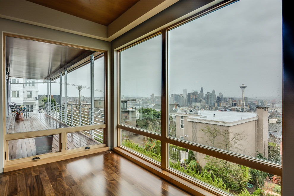 Example of a mid-sized minimalist medium tone wood floor sunroom design in Seattle with a standard ceiling