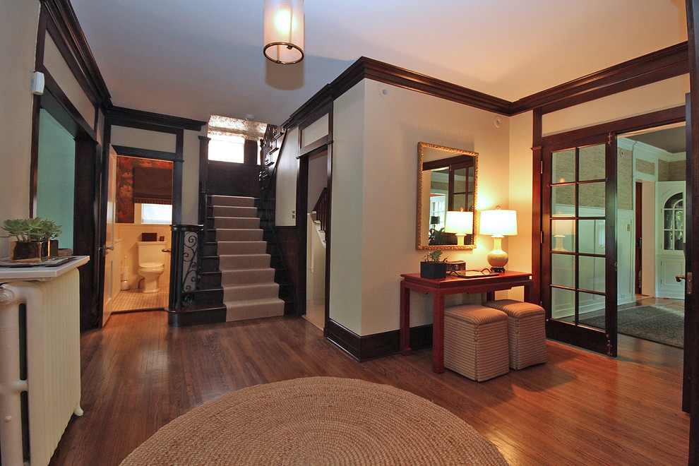 This is an example of a traditional foyer in Chicago with beige walls.