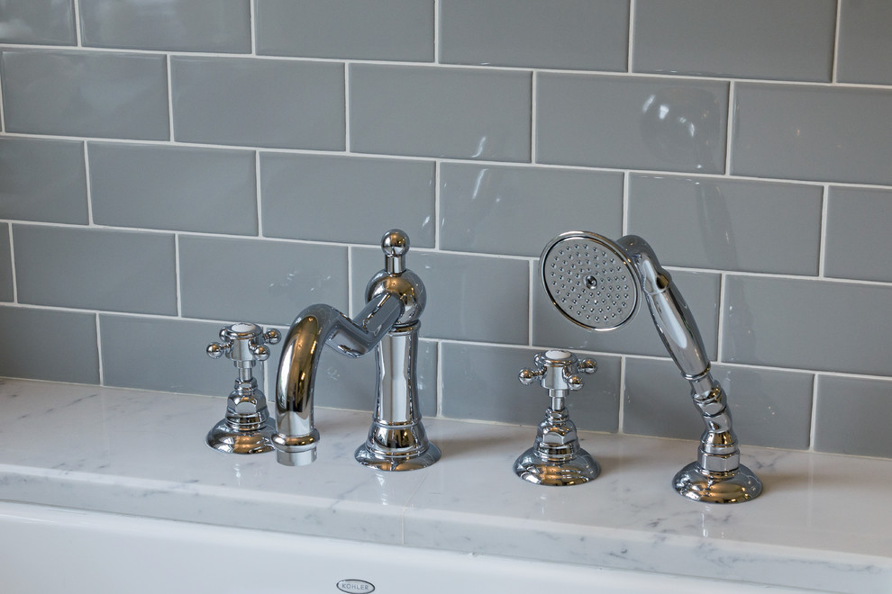 Example of a mid-sized transitional master gray tile and subway tile ceramic tile and white floor corner shower design with raised-panel cabinets, gray cabinets, an undermount tub, a two-piece toilet, beige walls, an undermount sink, marble countertops and a hinged shower door