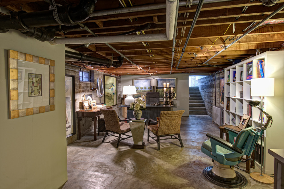 Example of a large eclectic underground concrete floor and gray floor basement design with beige walls and no fireplace
