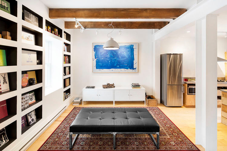 Photo of a mid-sized scandinavian basement in San Francisco with blue walls, bamboo floors, no fireplace and a brick fireplace surround.