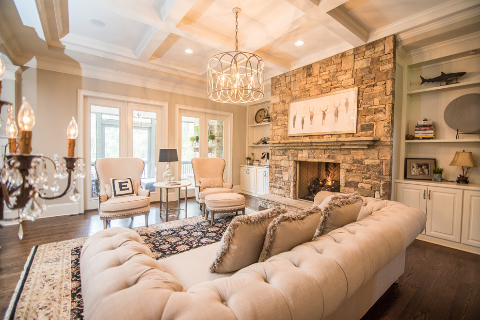 Traditional living room in Atlanta with beige walls, dark hardwood floors, a standard fireplace and a stone fireplace surround.
