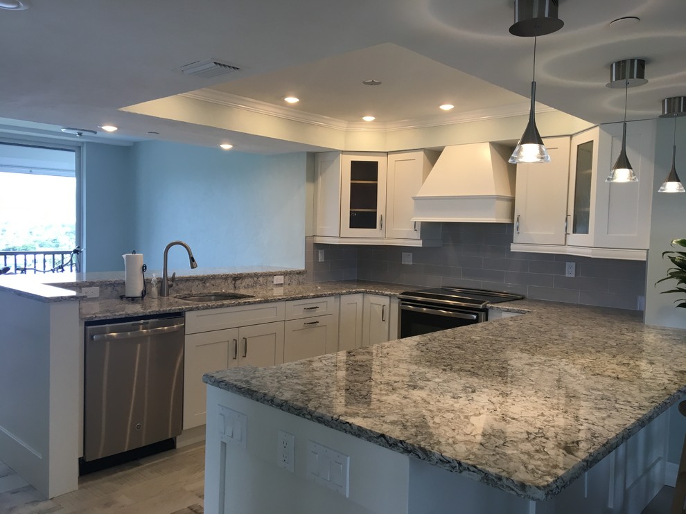 Mid-sized transitional u-shaped porcelain tile kitchen photo in Miami with a single-bowl sink, shaker cabinets, white cabinets, quartz countertops, gray backsplash, subway tile backsplash and stainless steel appliances
