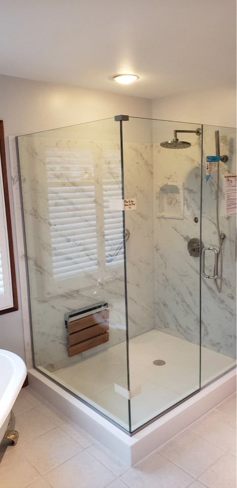 Inspiration for a mid-sized transitional master porcelain tile and gray floor claw-foot bathtub remodel with raised-panel cabinets, a two-piece toilet, blue walls, an undermount sink, solid surface countertops, a hinged shower door and multicolored countertops