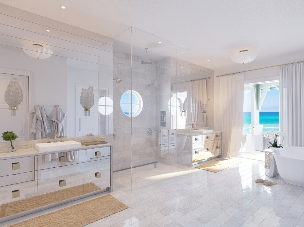 Design ideas for a large coastal ensuite bathroom in Tampa with flat-panel cabinets, beige cabinets, a freestanding bath, an alcove shower, a one-piece toilet, white tiles, marble tiles, beige walls, limestone flooring, a built-in sink, marble worktops, beige floors, a hinged door, grey worktops, an enclosed toilet, double sinks and a built in vanity unit.