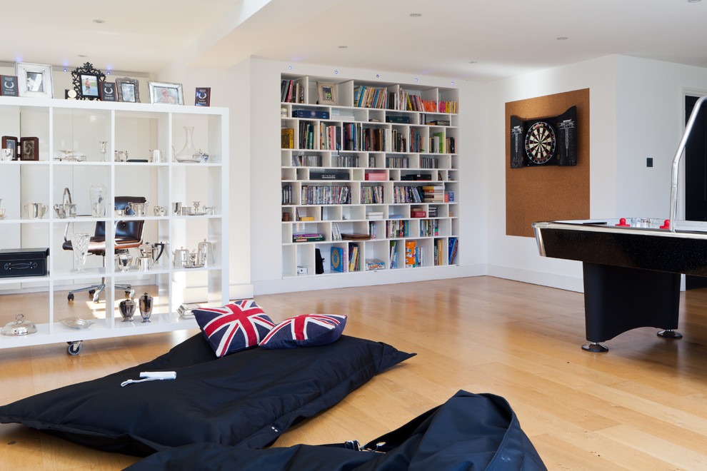 Contemporary family room in London with a game room.