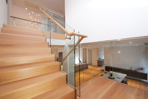 Inspiration for a large contemporary wood u-shaped staircase in Melbourne with wood risers.