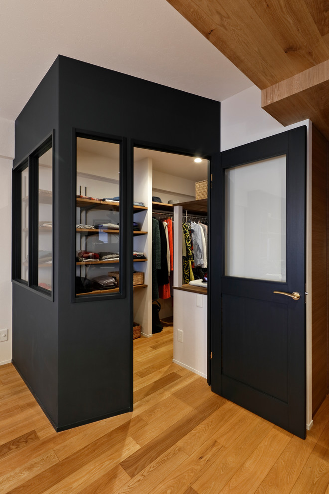 Small midcentury walk-in wardrobe in Other with open cabinets, medium hardwood floors and brown floor.