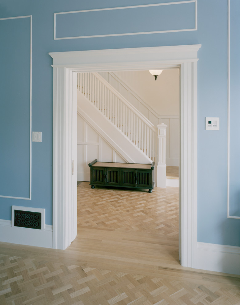 This is an example of a mid-sized traditional foyer in San Francisco with white walls, light hardwood floors and a white front door.