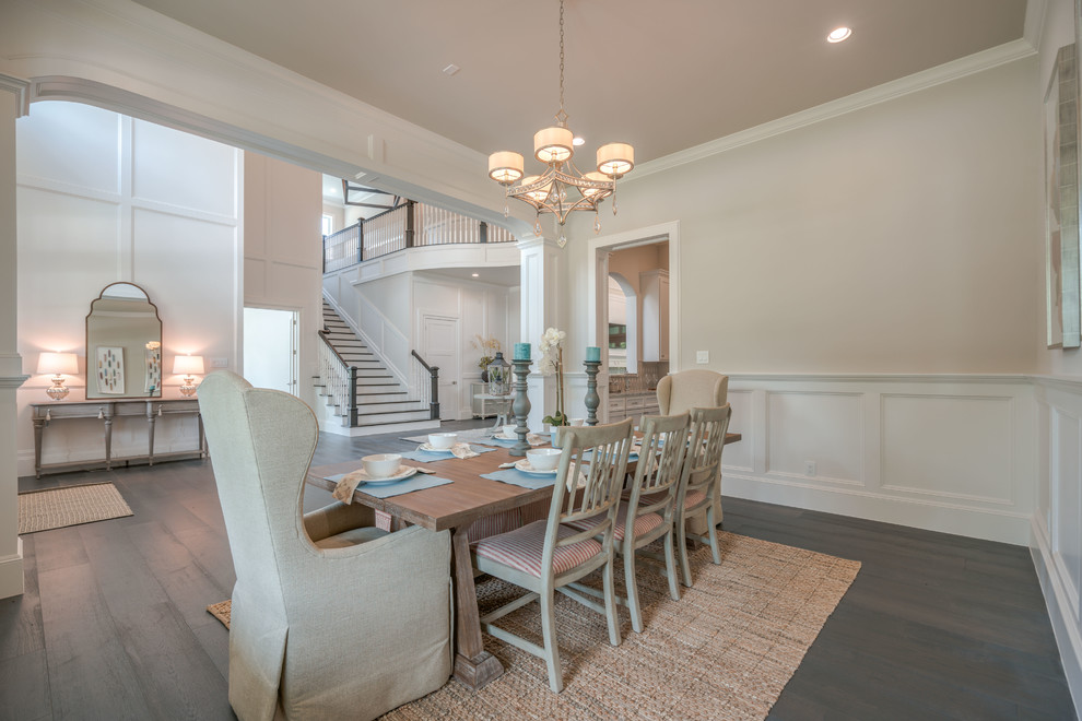 Large beach style separate dining room in Houston with beige walls, dark hardwood floors, no fireplace, brown floor and decorative wall panelling.