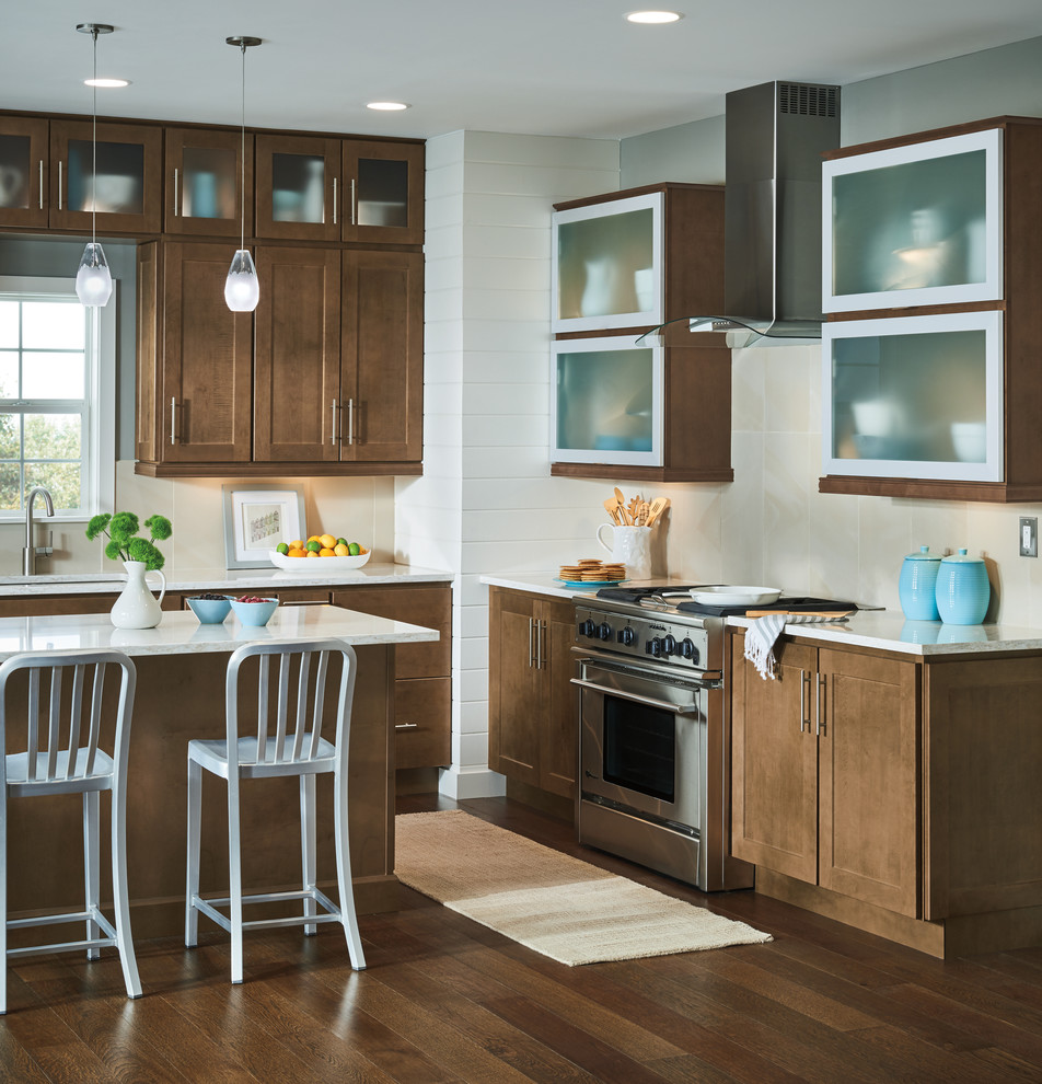 Inspiration for a mid-sized transitional medium tone wood floor and brown floor eat-in kitchen remodel with shaker cabinets, medium tone wood cabinets, stainless steel appliances, an island and white countertops