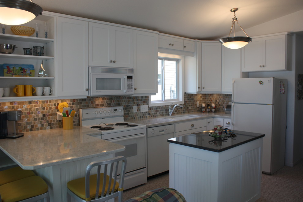 Eat-in kitchen - mid-sized transitional l-shaped eat-in kitchen idea with a double-bowl sink, white cabinets, multicolored backsplash, mosaic tile backsplash, white appliances, a peninsula, recessed-panel cabinets and granite countertops