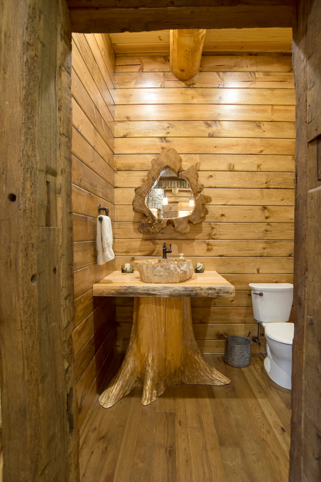 Design ideas for a small country 3/4 bathroom in Cleveland with a two-piece toilet, dark hardwood floors, a pedestal sink, wood benchtops, brown floor and brown benchtops.