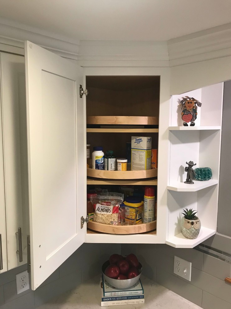 Example of a mid-sized transitional l-shaped porcelain tile and gray floor open concept kitchen design in Boston with a single-bowl sink, flat-panel cabinets, white cabinets, quartz countertops, gray backsplash, subway tile backsplash, stainless steel appliances, an island and white countertops