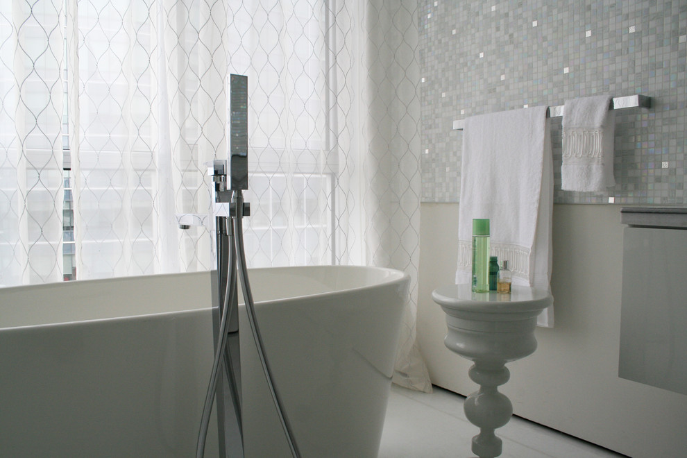 Inspiration for a contemporary bathroom in Montreal with a freestanding tub and mosaic tile.