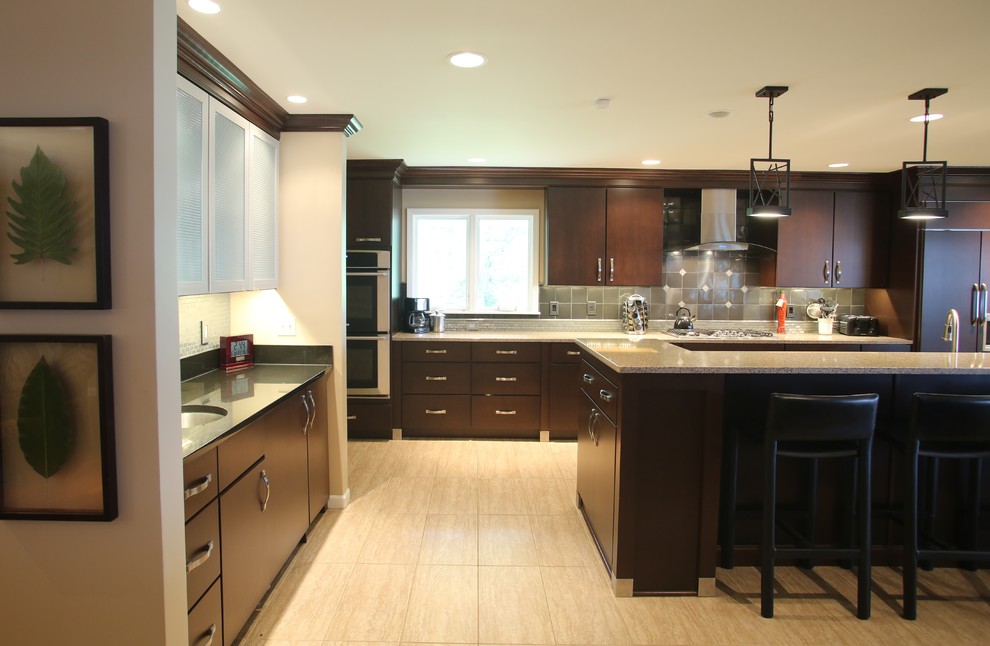 Inspiration for a large transitional galley ceramic tile open concept kitchen remodel in Chicago with an undermount sink, flat-panel cabinets, dark wood cabinets, quartz countertops, gray backsplash, stainless steel appliances, an island and metal backsplash