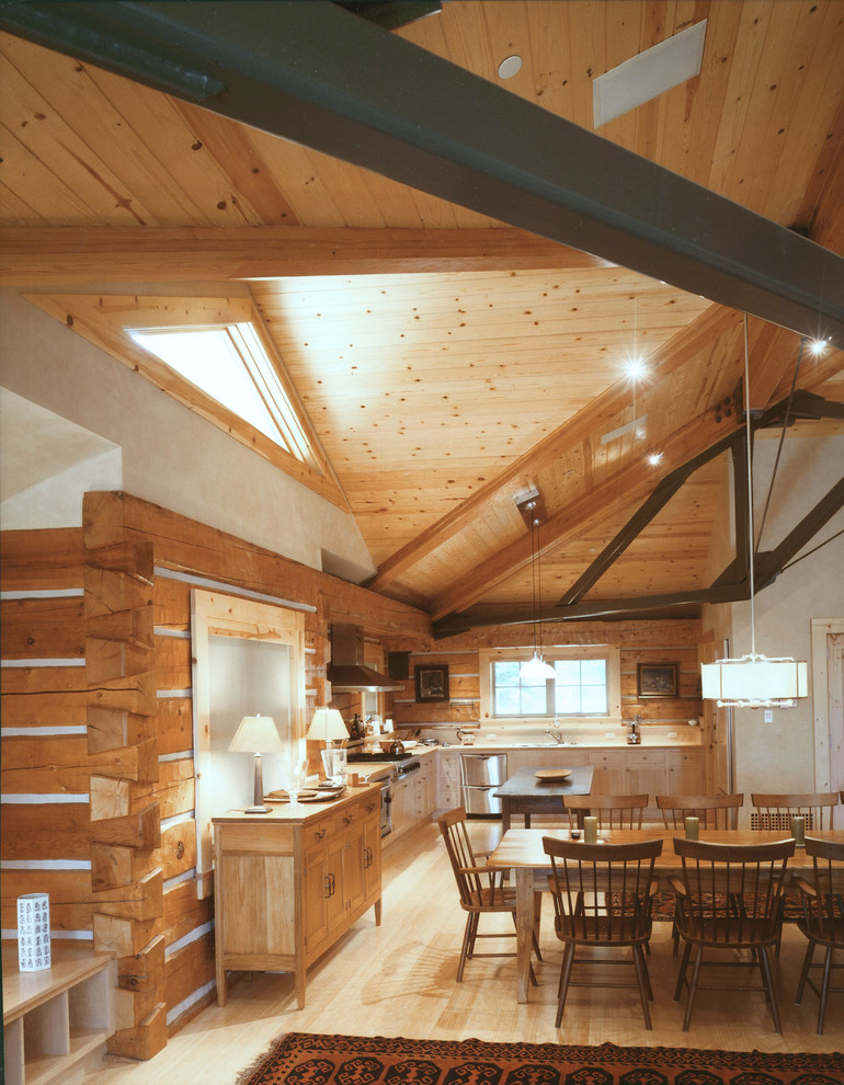 Eat-in kitchen - rustic l-shaped light wood floor eat-in kitchen idea with white cabinets, brown backsplash, wood backsplash and stainless steel appliances