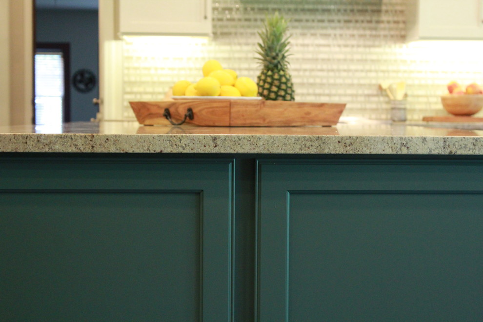 Example of a mid-sized transitional u-shaped open concept kitchen design with recessed-panel cabinets, green cabinets, stainless steel appliances and an island