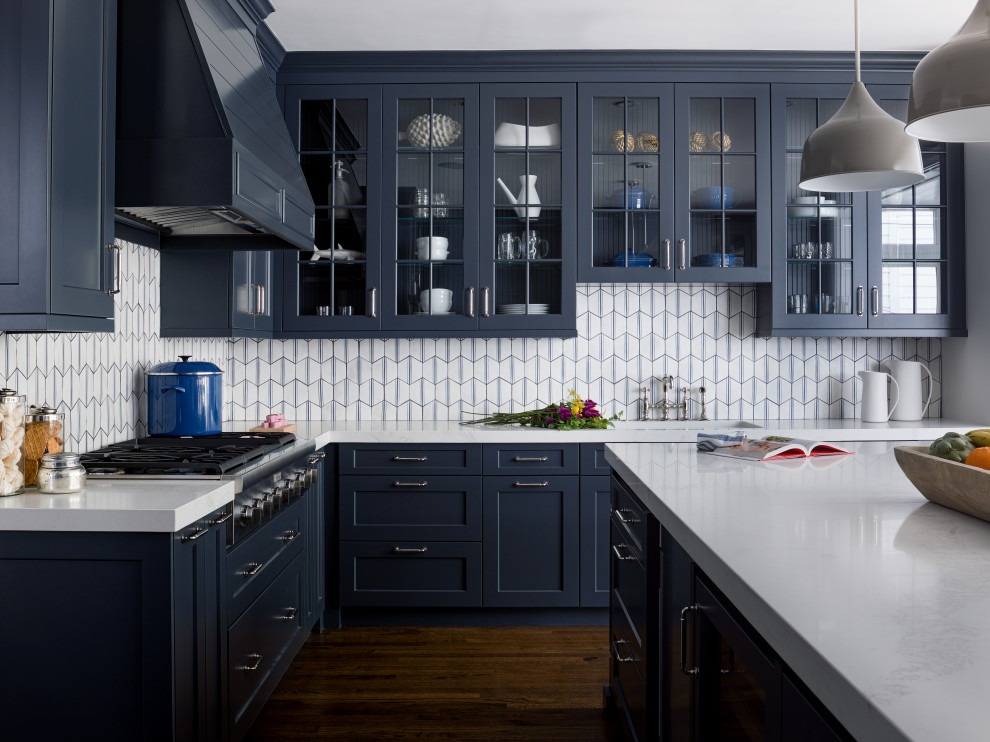 Kitchen - transitional l-shaped dark wood floor and brown floor kitchen idea in Chicago with an undermount sink, shaker cabinets, blue cabinets, white backsplash, stainless steel appliances, an island and white countertops
