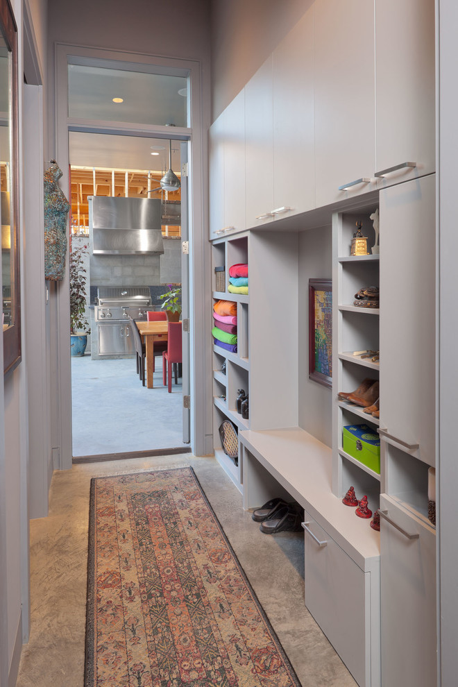 This is an example of a contemporary mudroom in Houston with grey walls.