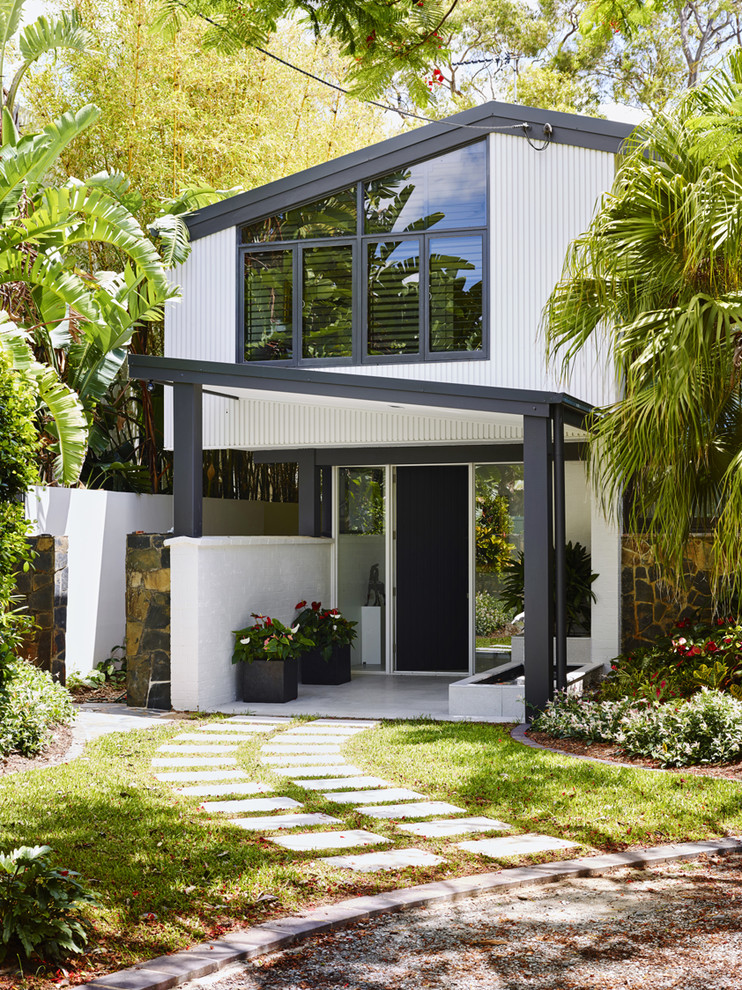 Photo of a mid-sized contemporary front door in Gold Coast - Tweed with white walls, a single front door and a glass front door.