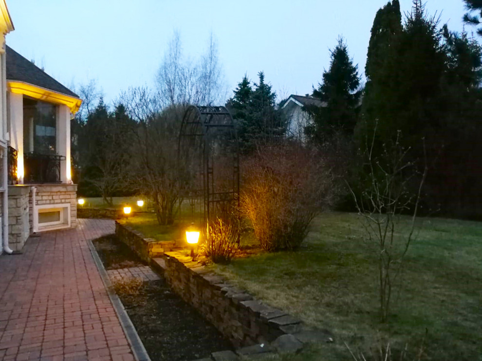 Источник вдохновения для домашнего уюта: весенний регулярный сад среднего размера на боковом дворе в стиле модернизм с подпорной стенкой, полуденной тенью, мощением клинкерной брусчаткой и с деревянным забором