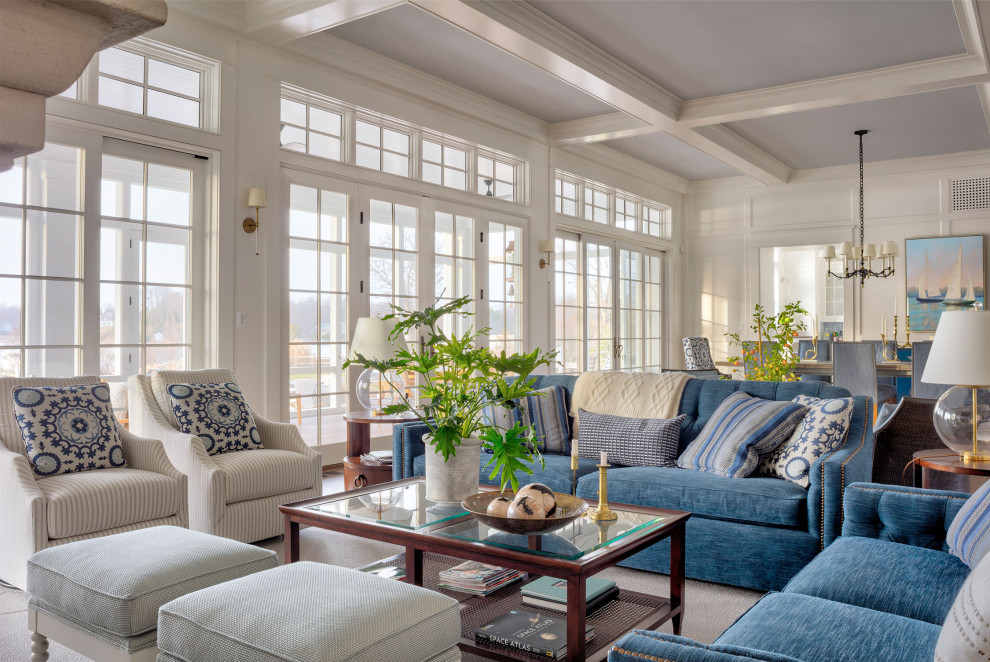 Example of a beach style open concept exposed beam living room design in Baltimore with white walls