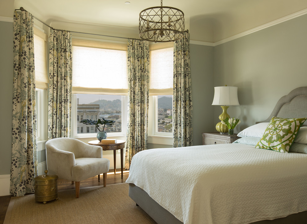 Transitional medium tone wood floor bedroom photo in San Francisco with gray walls