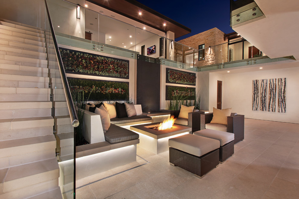 Photo of an expansive contemporary courtyard patio in Orange County with concrete pavers, no cover and a vertical garden.