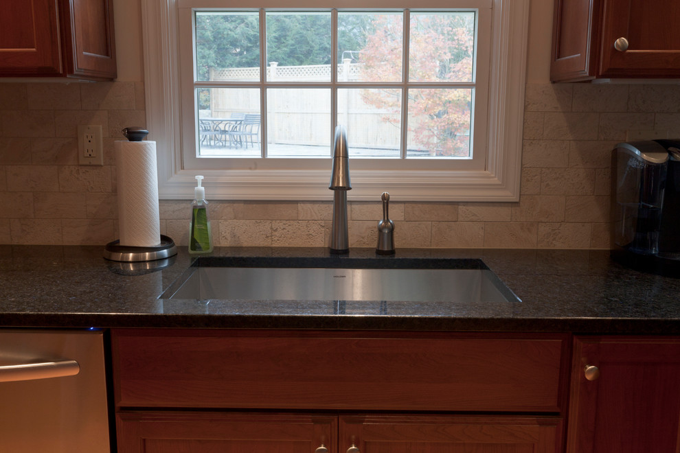 Mid-sized transitional l-shaped light wood floor eat-in kitchen photo in Bridgeport with an undermount sink, recessed-panel cabinets, medium tone wood cabinets, granite countertops, white backsplash, stone tile backsplash, stainless steel appliances and a peninsula
