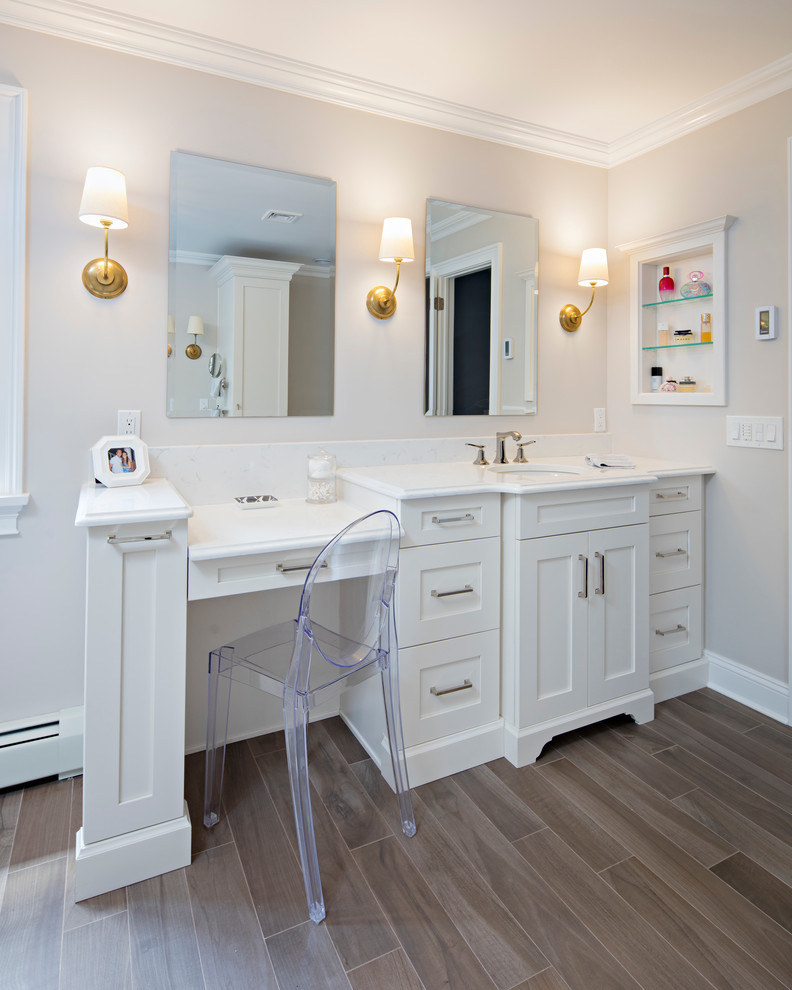 Example of a large transitional master gray tile and marble tile porcelain tile and brown floor freestanding bathtub design in New York with shaker cabinets, white cabinets, gray walls, an undermount sink, marble countertops, a hinged shower door and white countertops