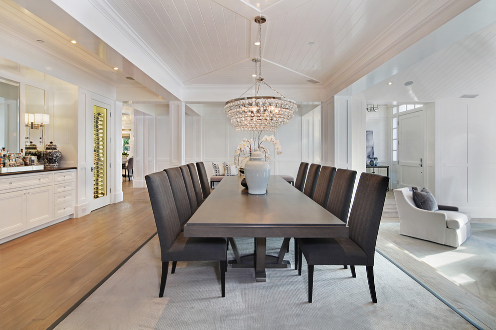 Transitional dining room in Orange County with white walls, medium hardwood floors and no fireplace.