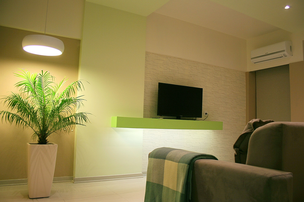 Photo of a small modern family room in Other with green walls, ceramic floors, no fireplace and a freestanding tv.