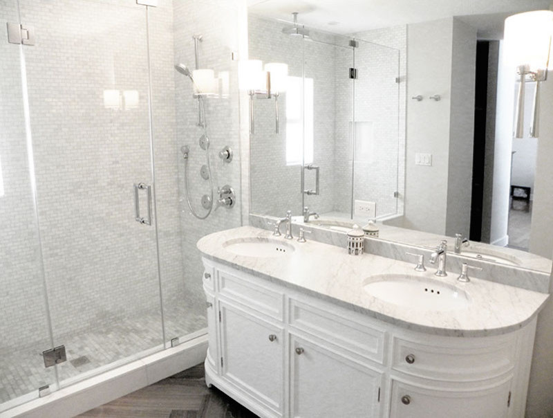 Inspiration for a mid-sized contemporary 3/4 bathroom in Phoenix with recessed-panel cabinets, white cabinets, an alcove shower, stone tile, white walls, medium hardwood floors, an undermount sink, marble benchtops, gray tile, white tile, brown floor and a hinged shower door.