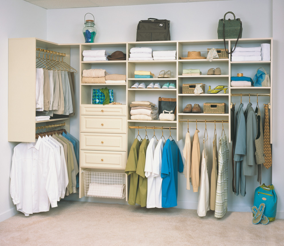Mid-sized traditional gender-neutral walk-in wardrobe in Orange County with raised-panel cabinets, light wood cabinets, carpet and beige floor.