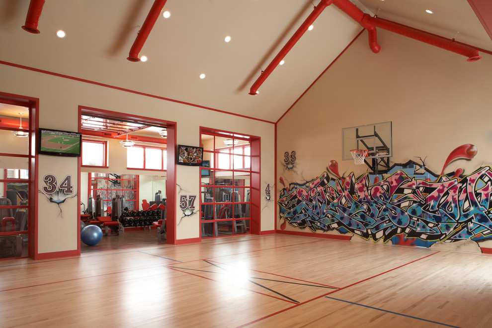 Design ideas for an expansive industrial indoor sport court in Minneapolis with white walls and light hardwood floors.