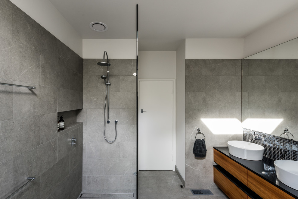Inspiration for a modern master bathroom in Melbourne with a freestanding tub, an open shower, multi-coloured walls, ceramic floors and a vessel sink.