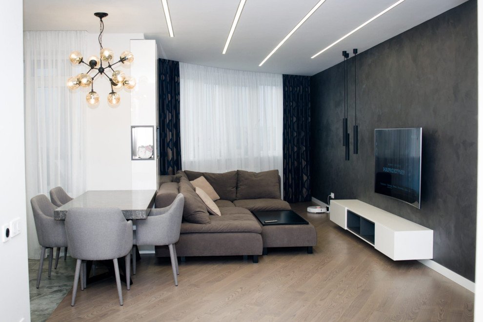 Mid-sized contemporary living room in Moscow with a library, black walls, laminate floors, a standard fireplace, a tile fireplace surround, a wall-mounted tv, grey floor and wallpaper.