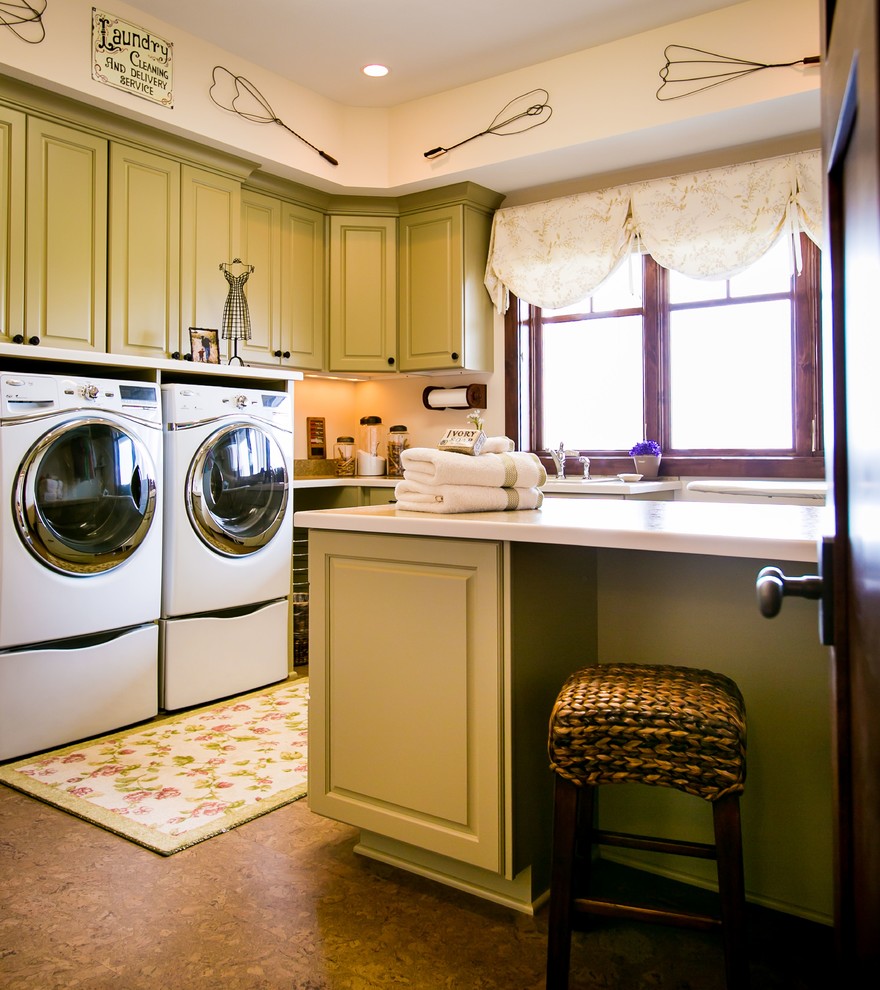 This is an example of a traditional laundry room in Other with green cabinets.