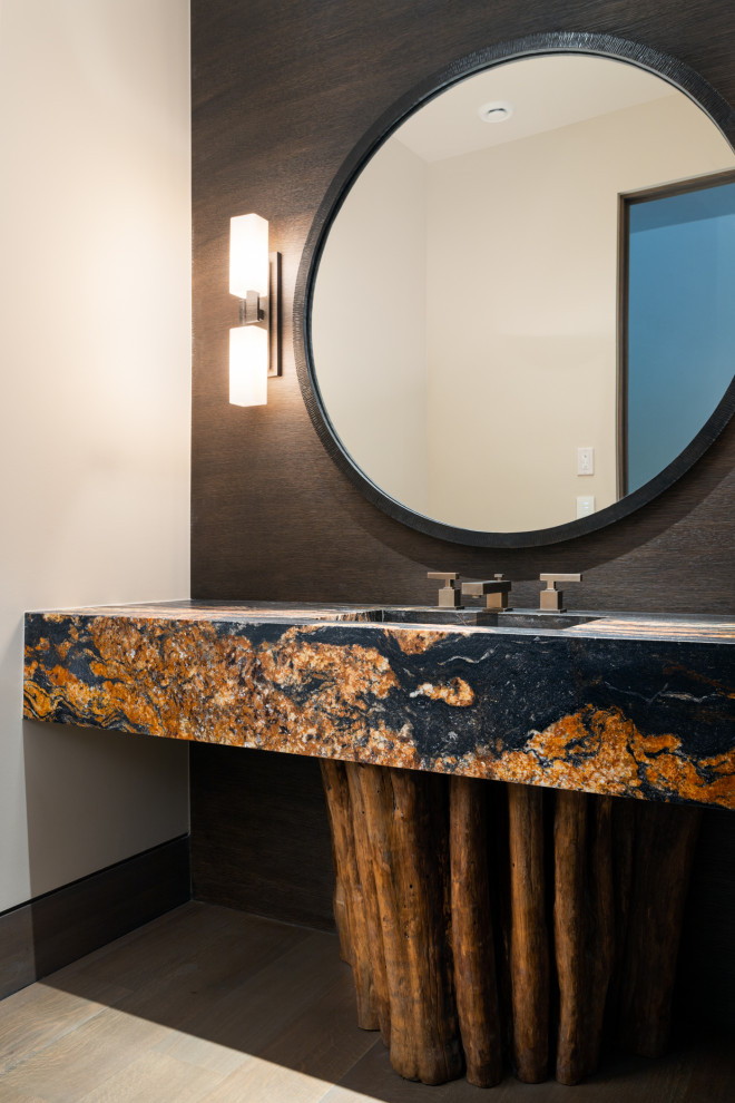 Powder room - mid-sized asian medium tone wood floor, brown floor and wallpaper powder room idea in Salt Lake City with black cabinets, brown walls, an undermount sink, multicolored countertops, a floating vanity and onyx countertops