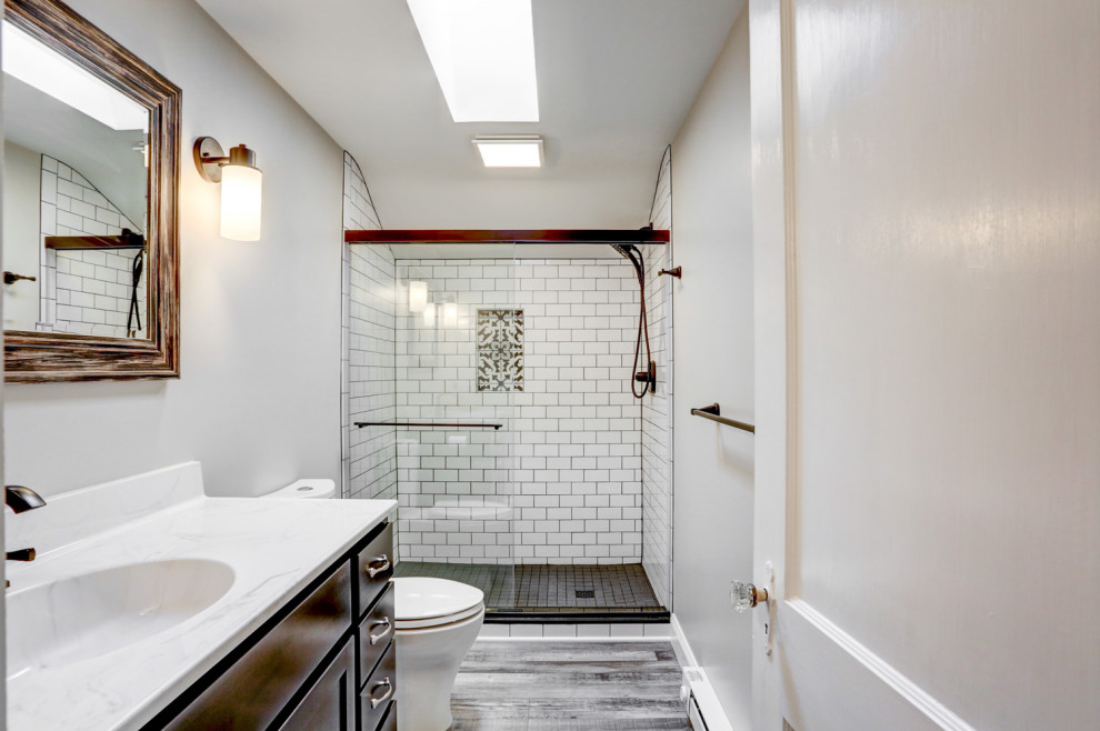 Inspiration for a small modern master white tile and ceramic tile vinyl floor, brown floor and single-sink bathroom remodel in Other with brown cabinets, a two-piece toilet, gray walls, an integrated sink, marble countertops, white countertops and a freestanding vanity