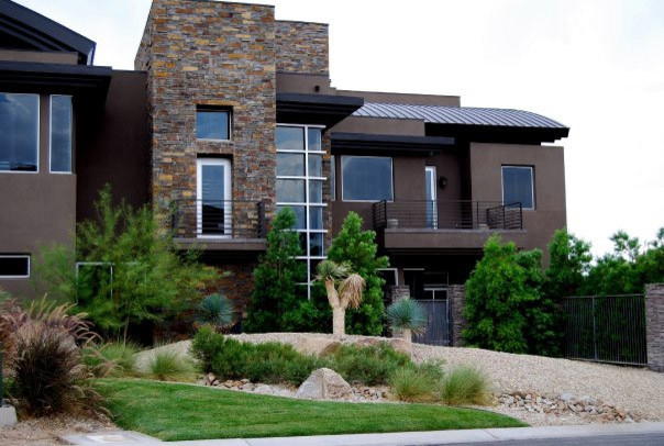 This is an example of a large transitional two-storey beige exterior in Las Vegas with mixed siding.