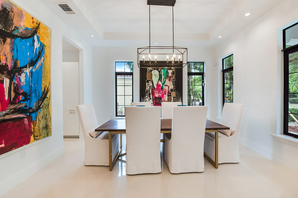 Photo of a contemporary dining room in Austin with white walls and white floor.
