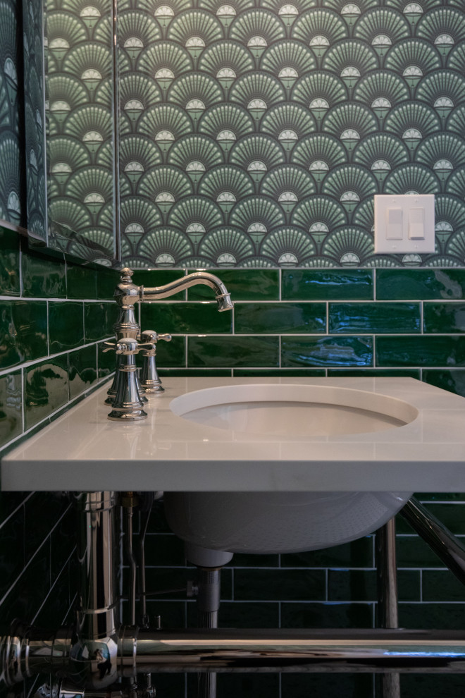 Mid-sized transitional green tile and ceramic tile mosaic tile floor, multicolored floor and wallpaper powder room photo with a one-piece toilet, green walls, an undermount sink, solid surface countertops and white countertops