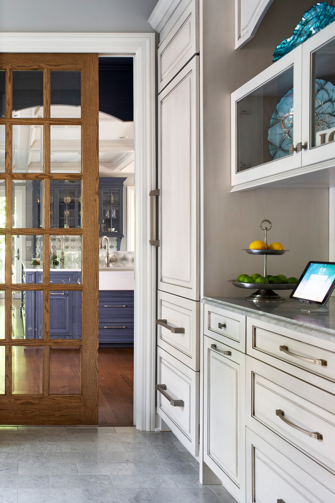 Inspiration for a mid-sized eclectic medium tone wood floor and brown floor kitchen remodel in New York with a farmhouse sink, beaded inset cabinets, blue cabinets, quartz countertops, white backsplash, glass sheet backsplash, stainless steel appliances, two islands and white countertops