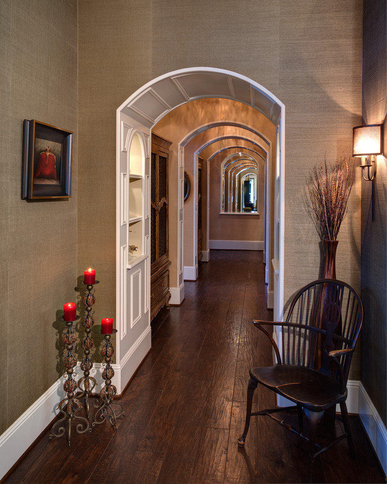 Large traditional hallway in Orange County with green walls, dark hardwood floors and brown floor.
